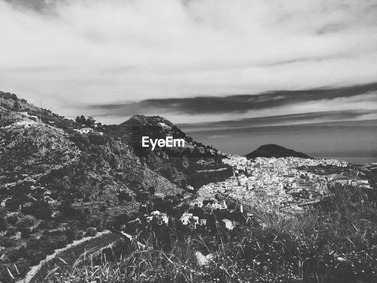 High angle shot of countryside landscape against clouds