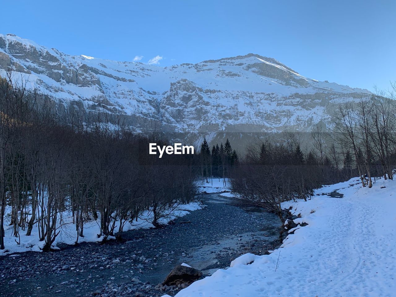 Scenic view of snow covered mountains against sky