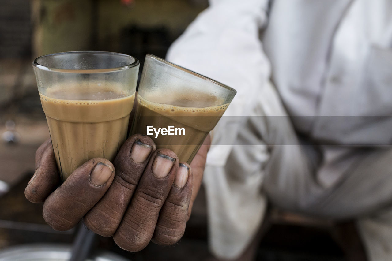 Close-up of hand holding chai tea