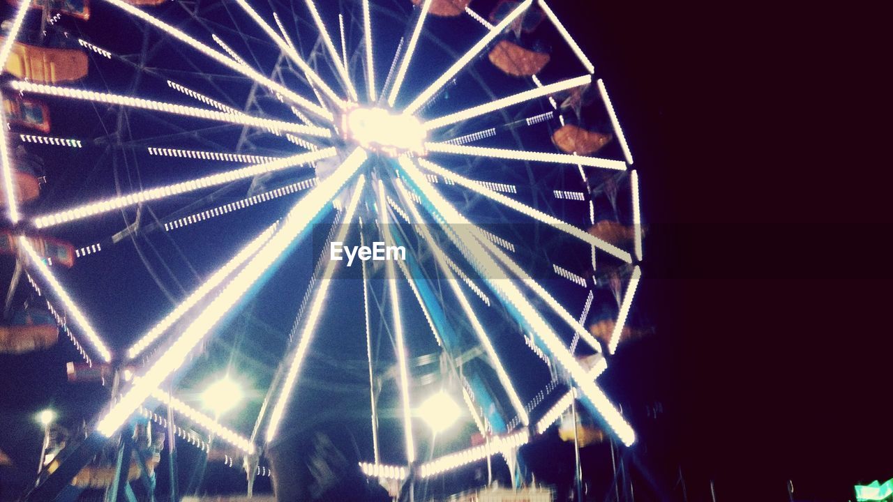 LOW ANGLE VIEW OF ILLUMINATED FERRIS WHEEL