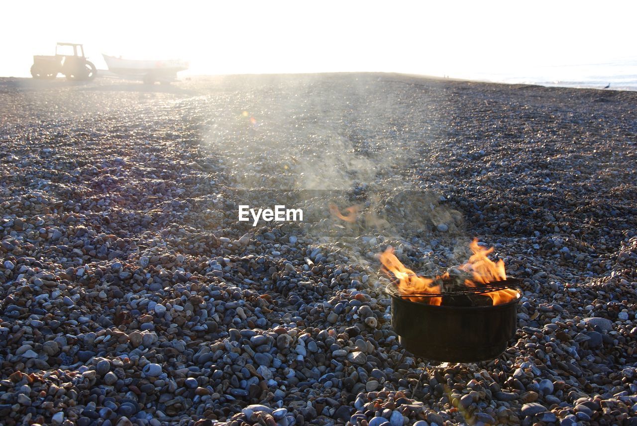 View of burning barbecue on beach