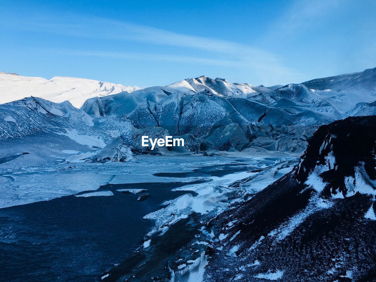 Scenic view of frozen lake against mountain range