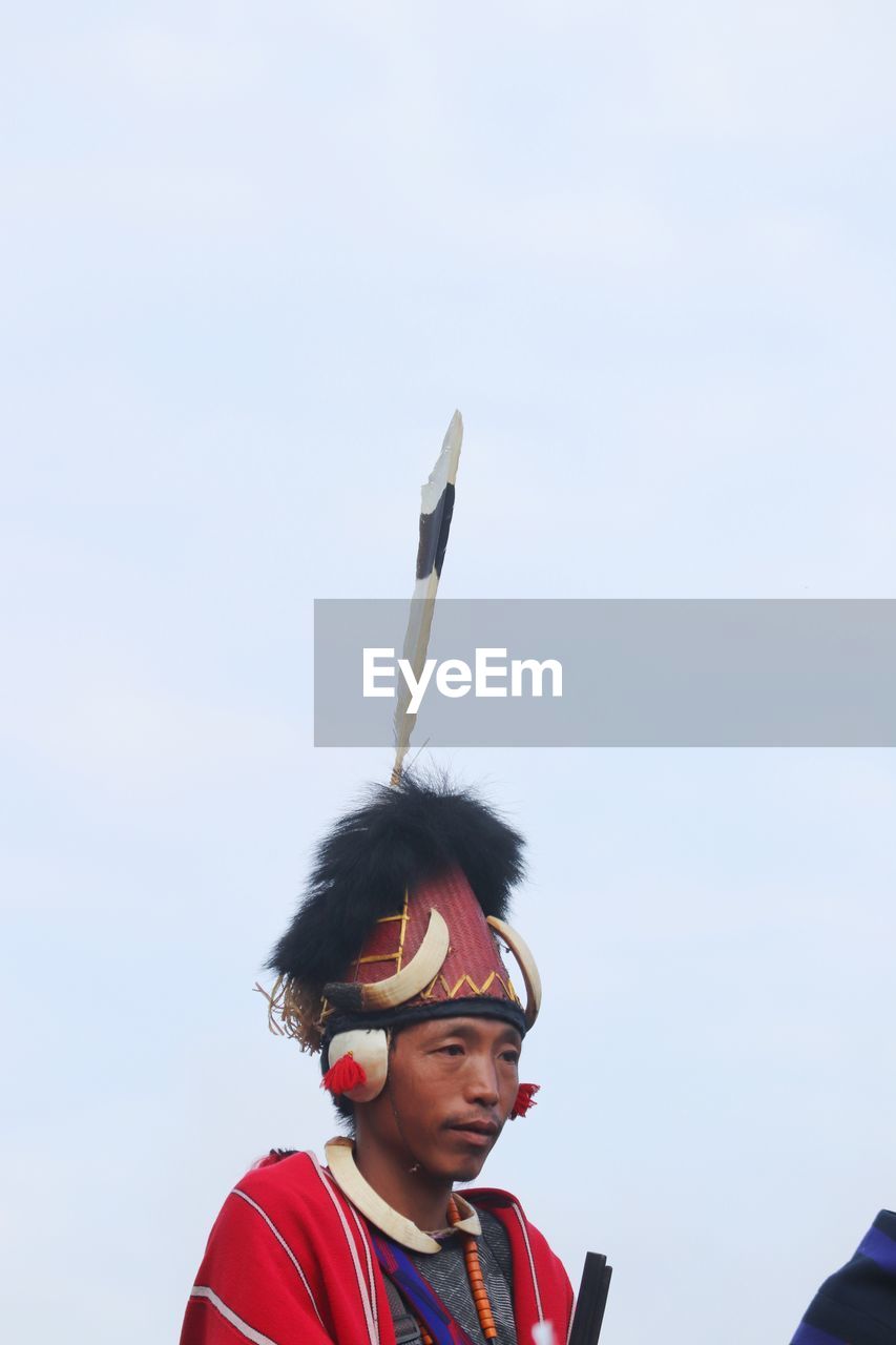 Rear view of man standing against clear sky