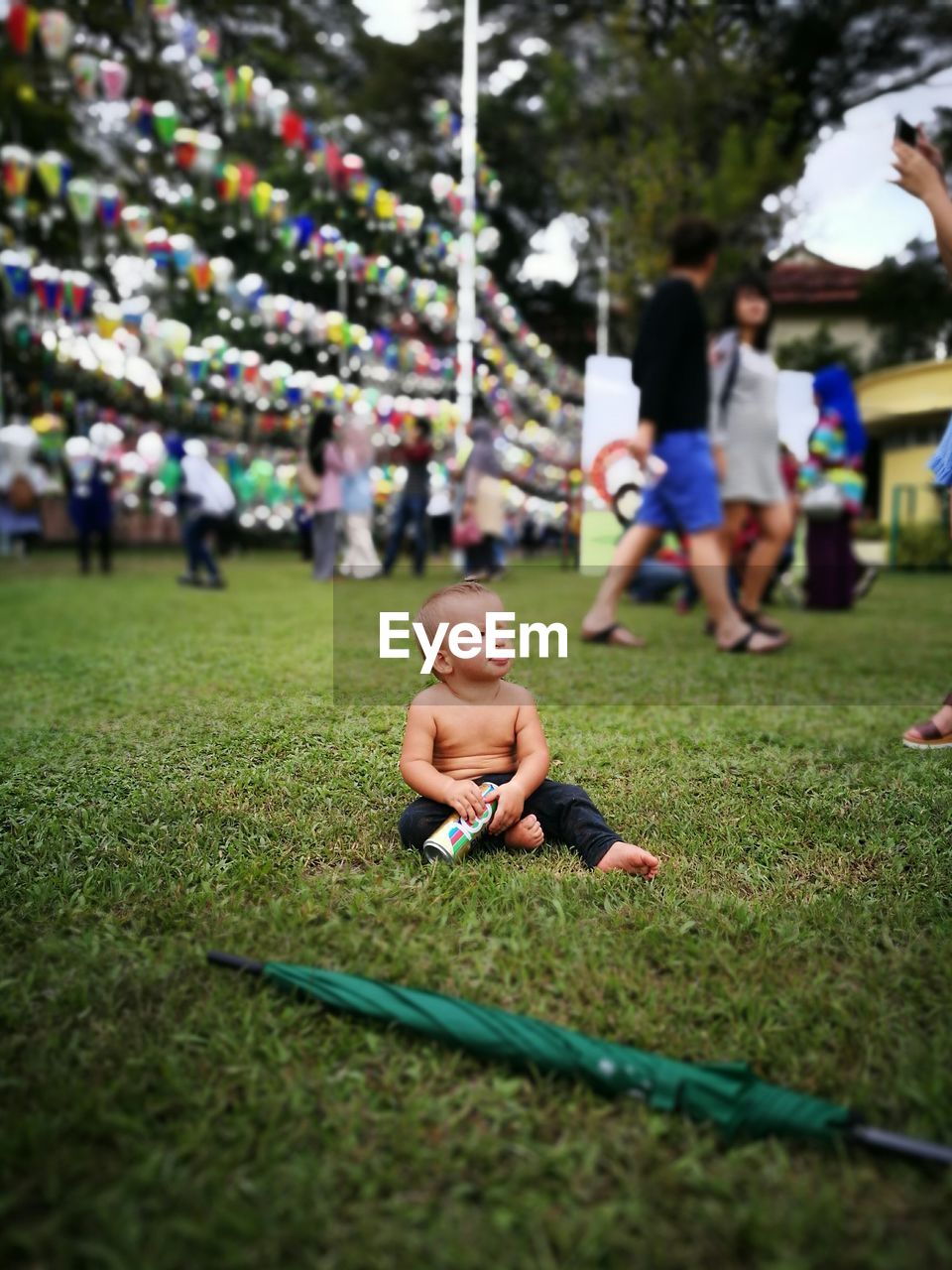 BOY PLAYING WITH LAWN IN GRASS