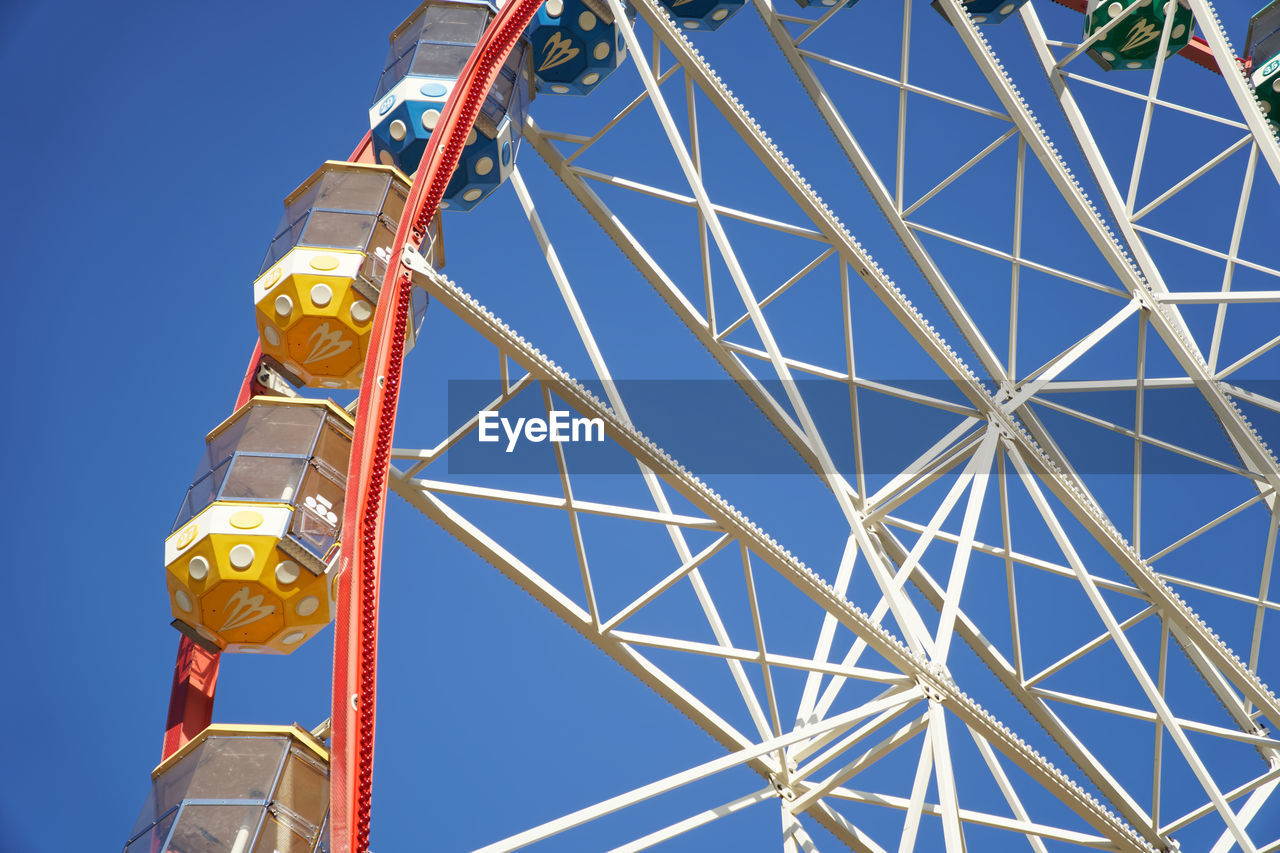 Carousel. ferris wheel on a blue background. carriages of the big wheel.