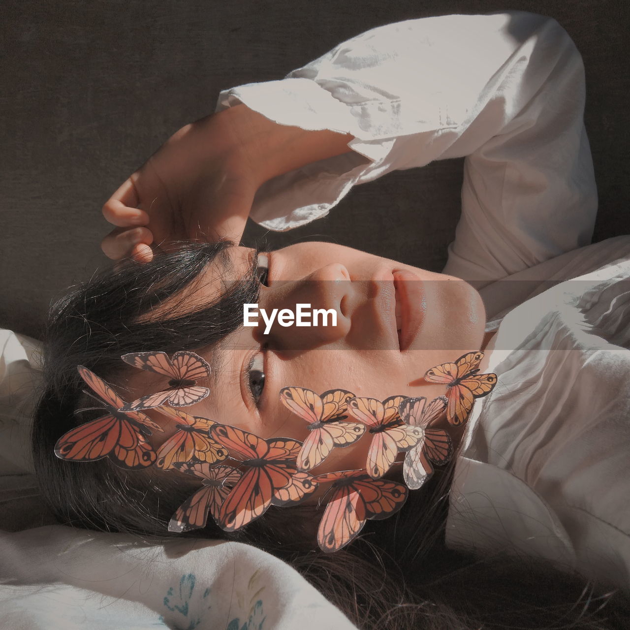 Portrait of teenage girl with decorations lying on bed