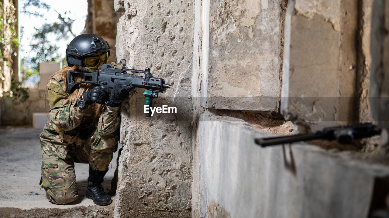 rear view of army soldiers standing in abandoned building