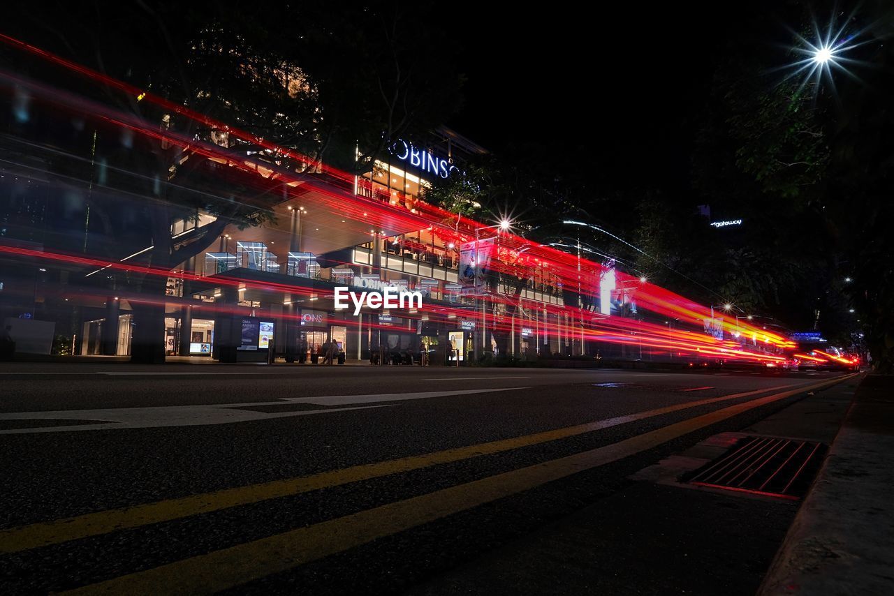 LIGHT TRAILS ON ROAD AT NIGHT