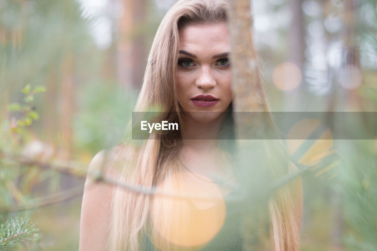 PORTRAIT OF A BEAUTIFUL YOUNG WOMAN WITH EYES CLOSED