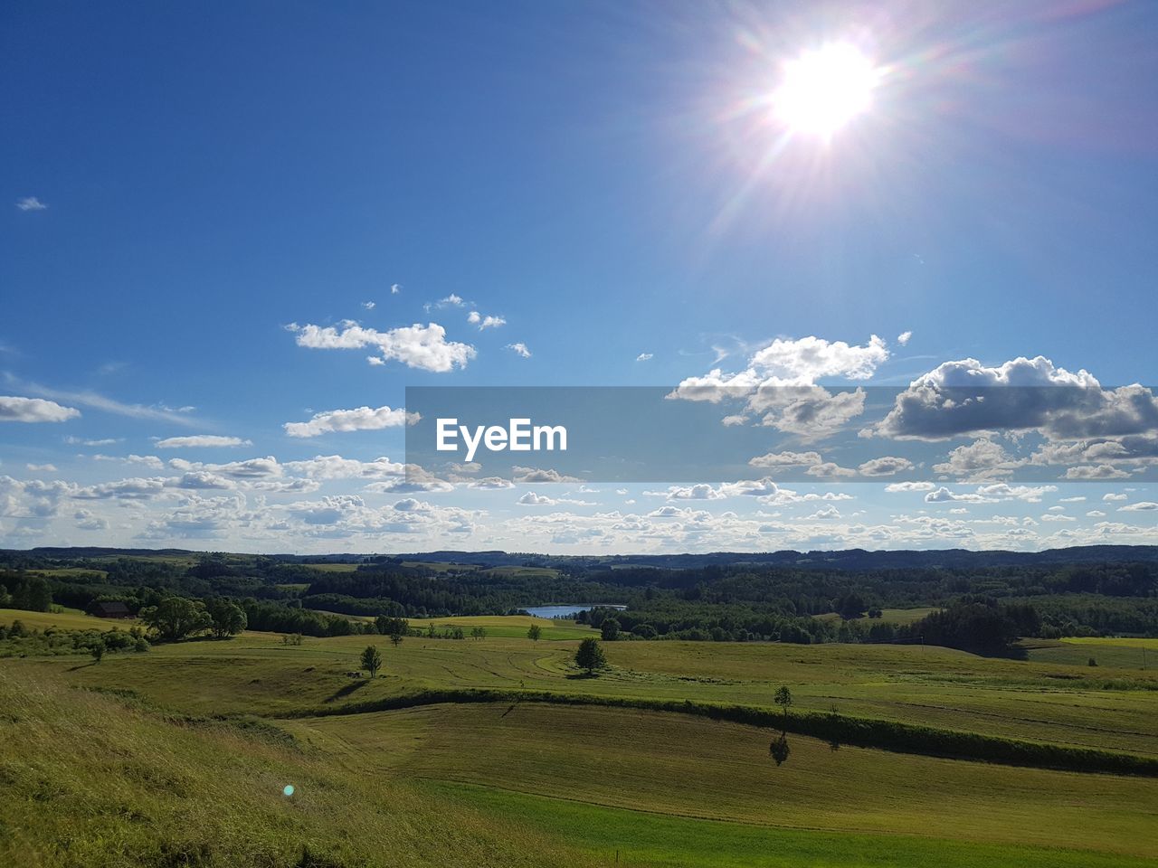 Scenic view of landscape against sky on sunny day