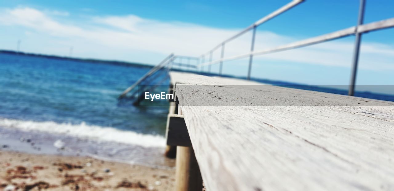 Wooden railing on beach against sky. beautiful beach in kalundborg city