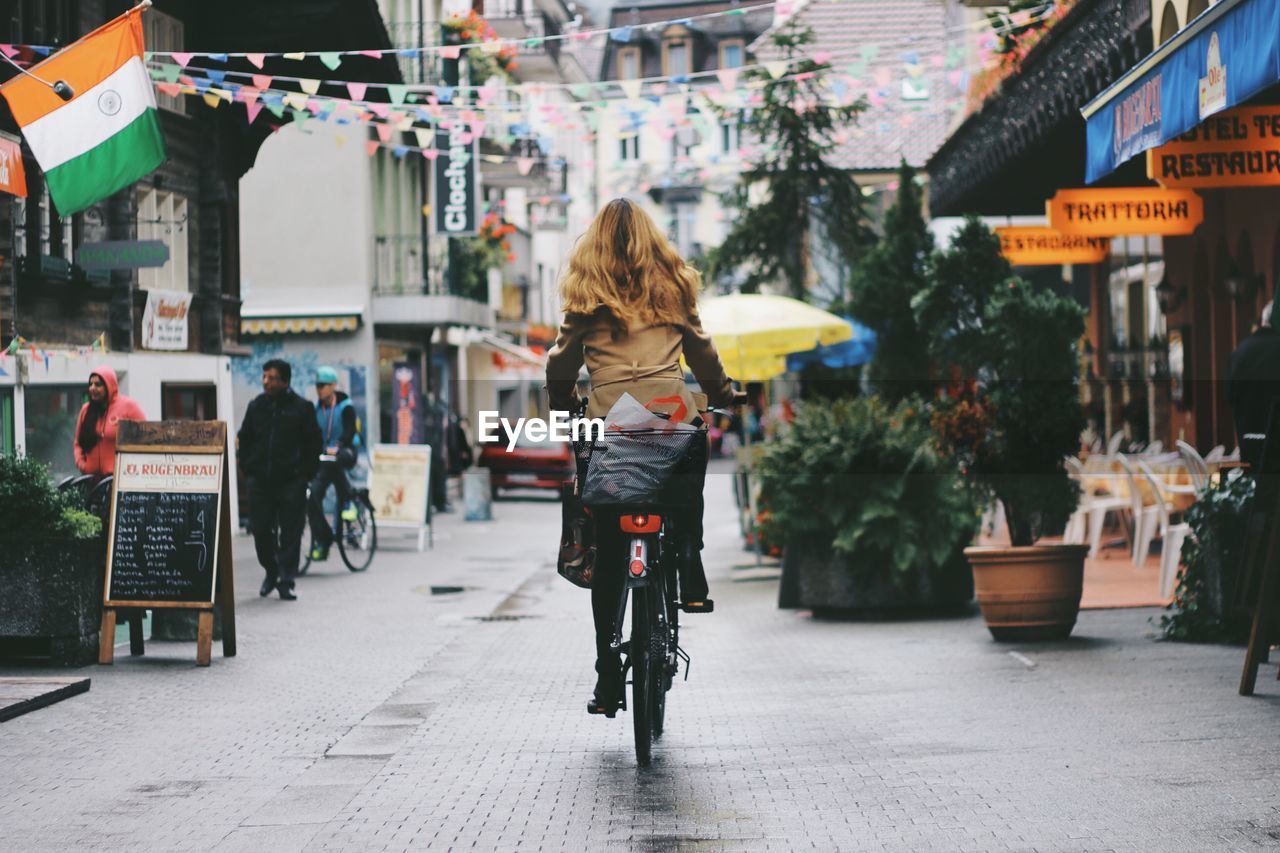 Rear view of woman walking on street