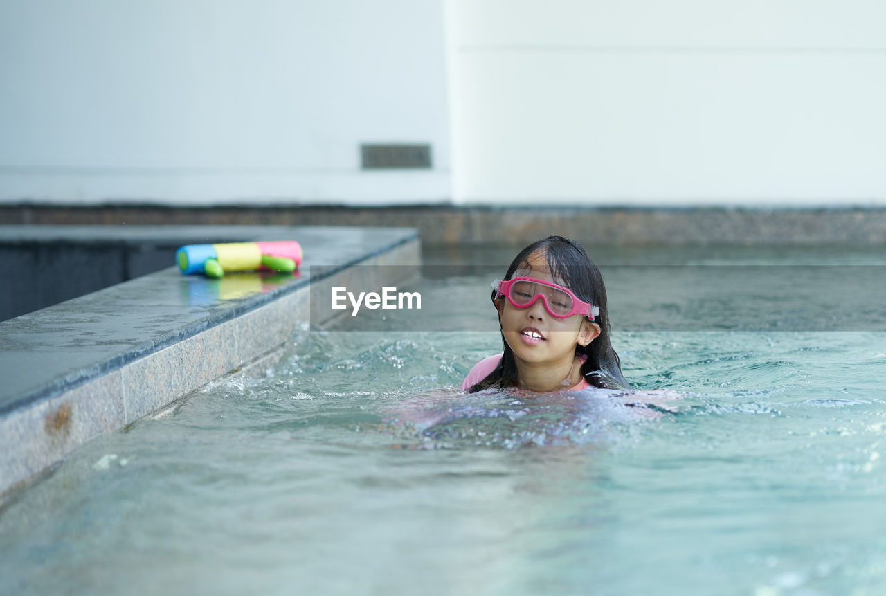 Portrait of girl swimming in pool