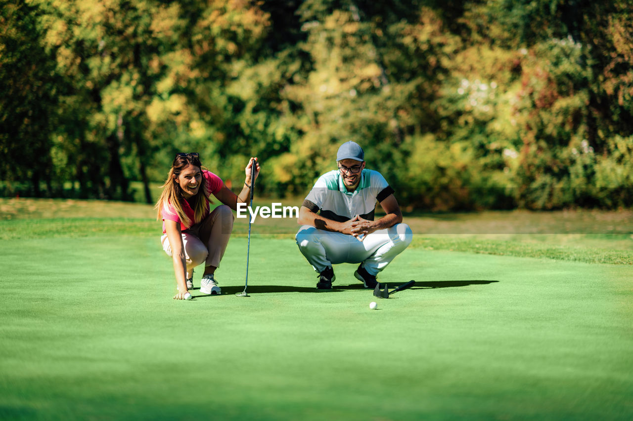 Golf lifestyle. young couple having fun on the golf course
