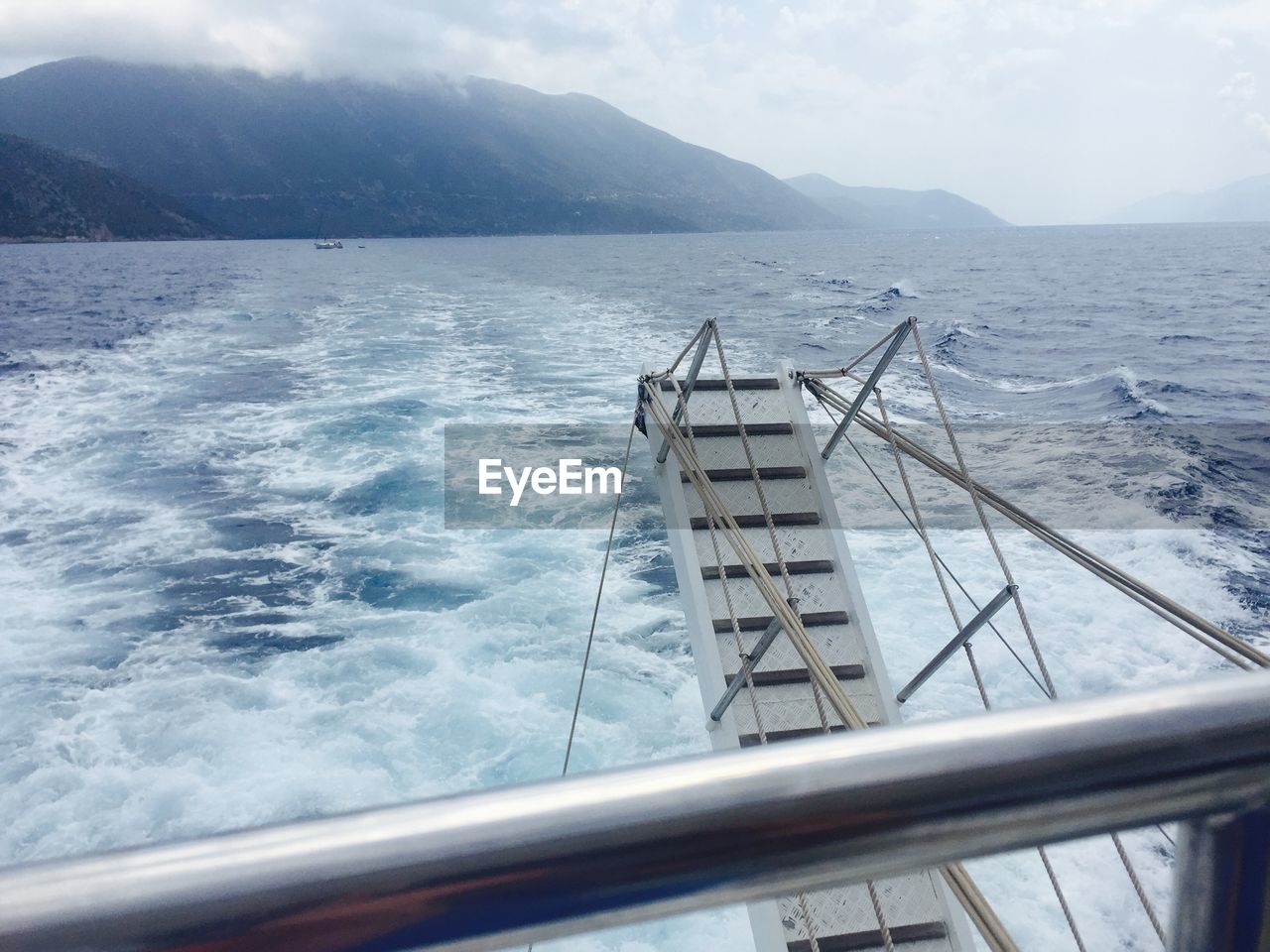 Gangway of ship over wake in sea