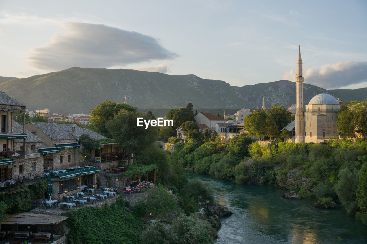 Panoramic view of buildings and mountains against sky in mostar
