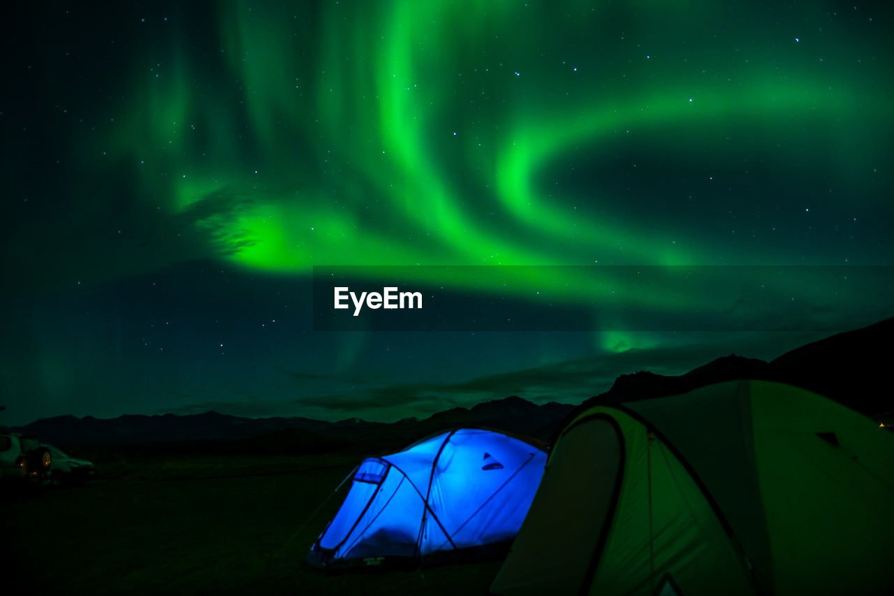 TENT AGAINST SKY AT NIGHT