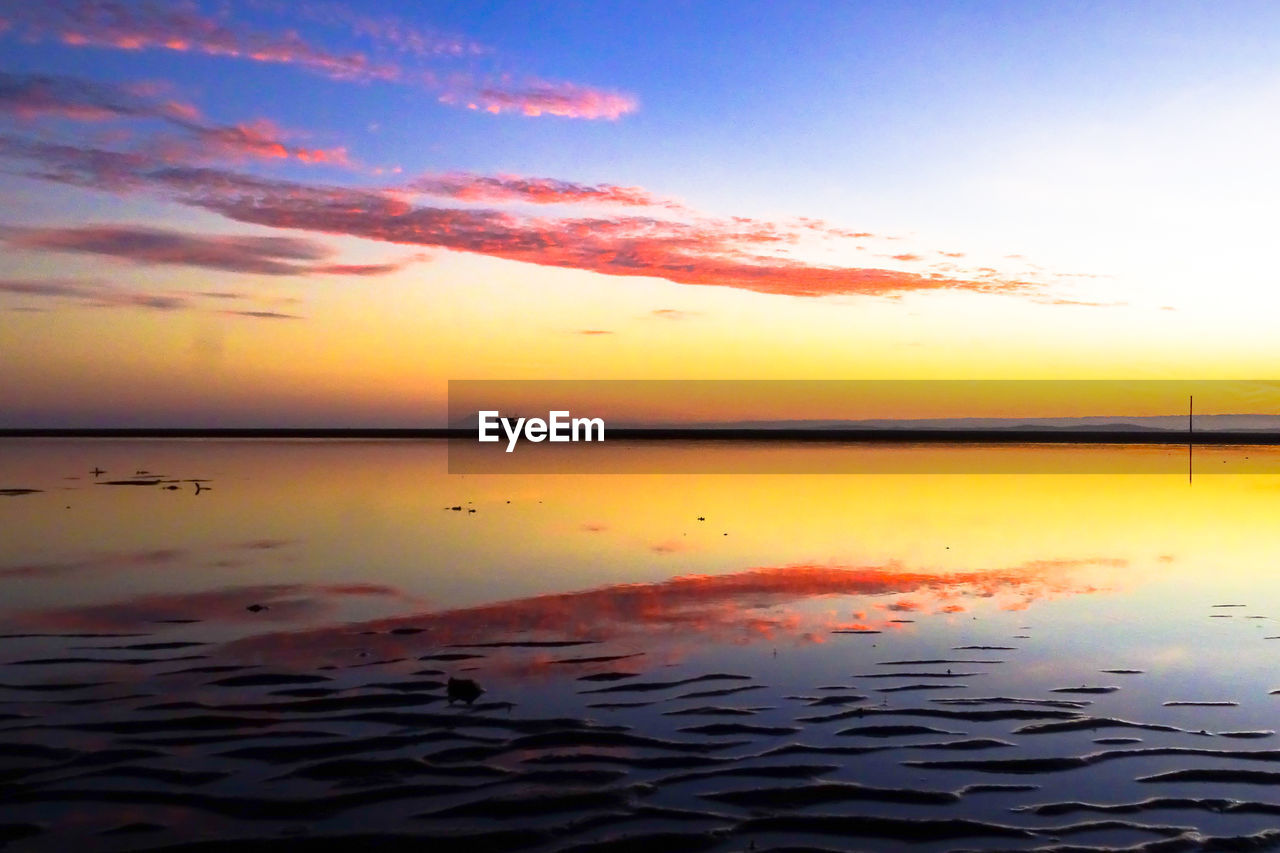SCENIC VIEW OF SEA AGAINST ORANGE SKY