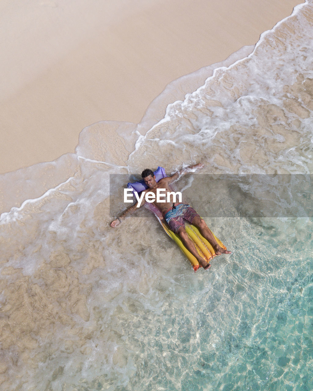Aerial view of man lying on beach