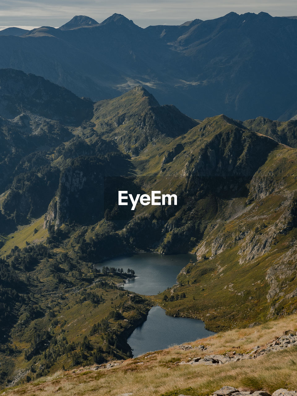 Scenic view of lake and mountains against sky