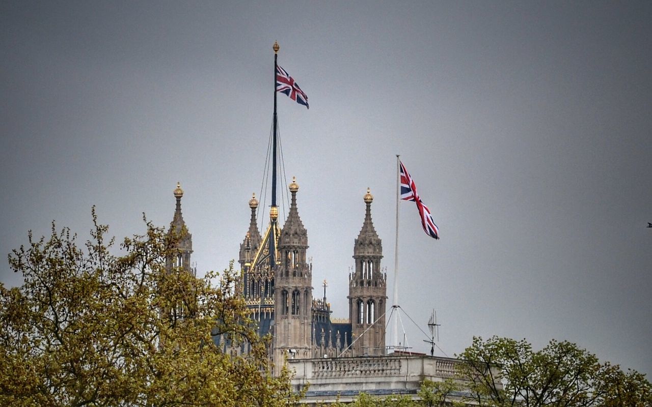 Low angle view of british flag on building against sky