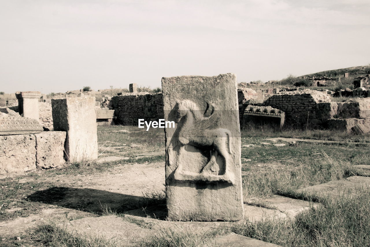 STONE CROSS IN FRONT OF TEMPLE