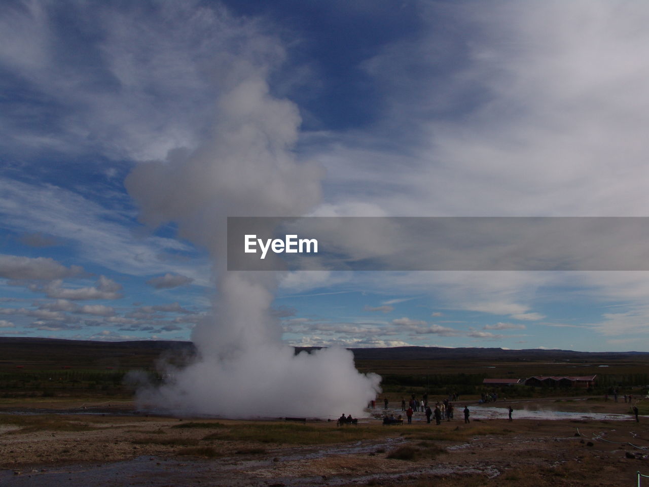 Panoramic view of blowhole on landscape against sky