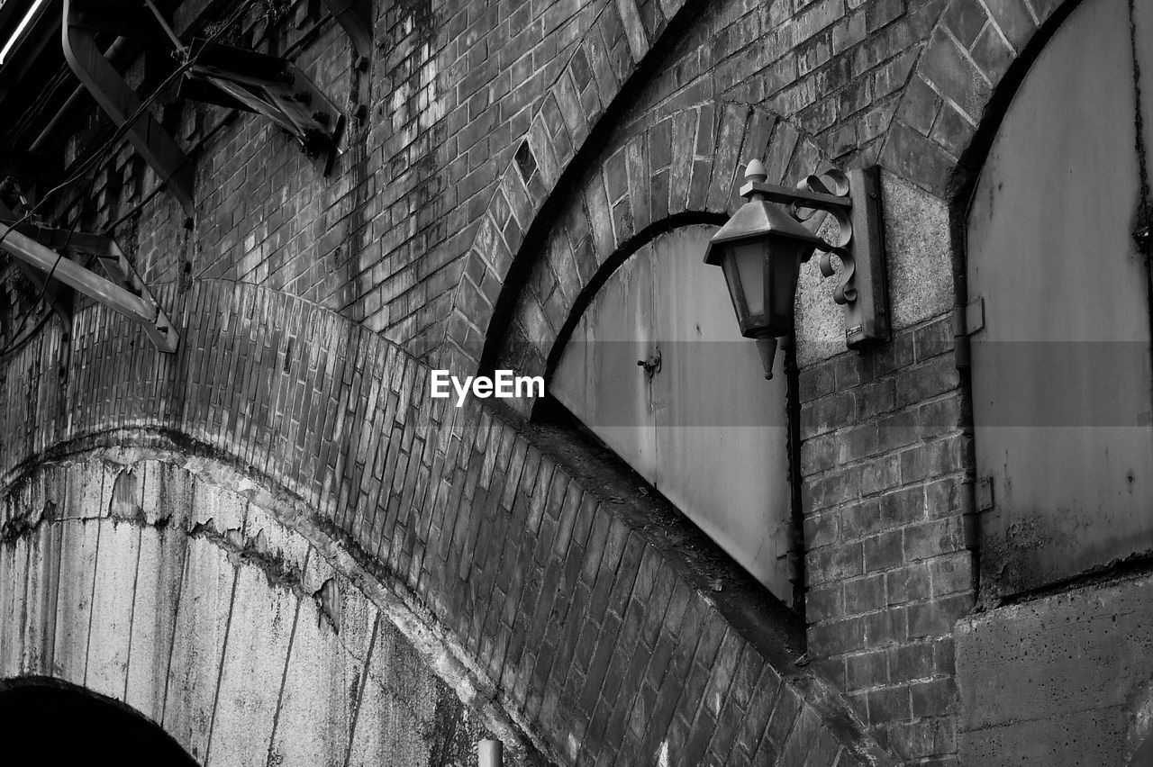 Low angle view of gas light mounted on old railroad station