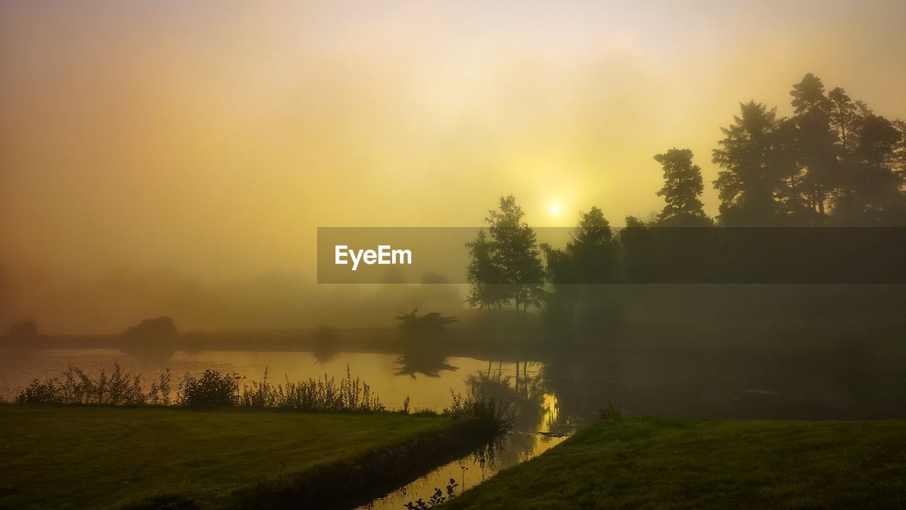 SCENIC VIEW OF LAKE DURING SUNSET