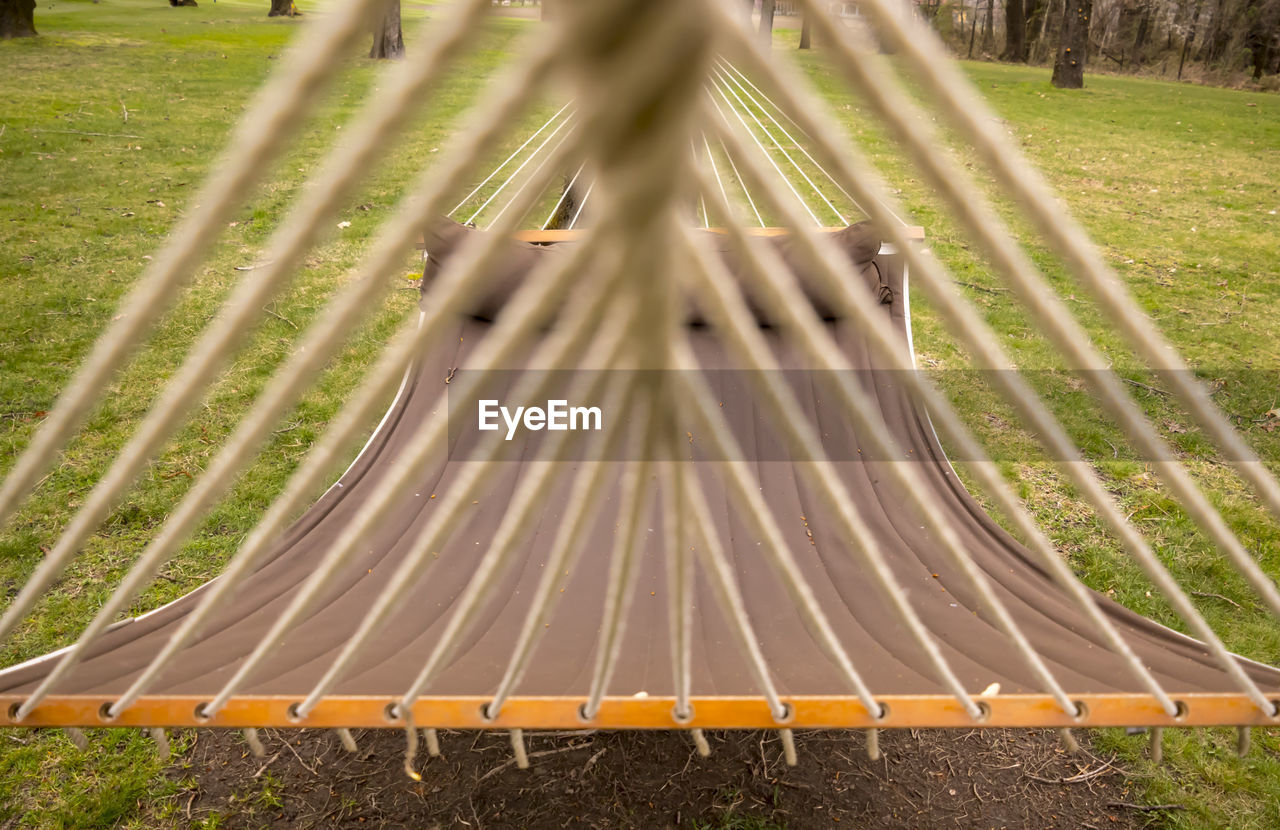 Close-up of hammock hanging over field at park