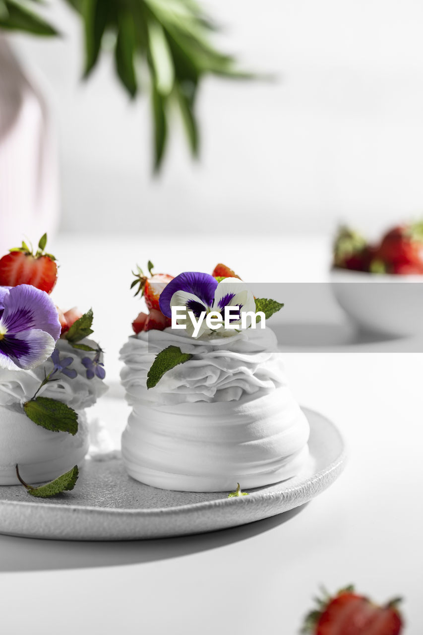 Meringue caked with pansies on a plate