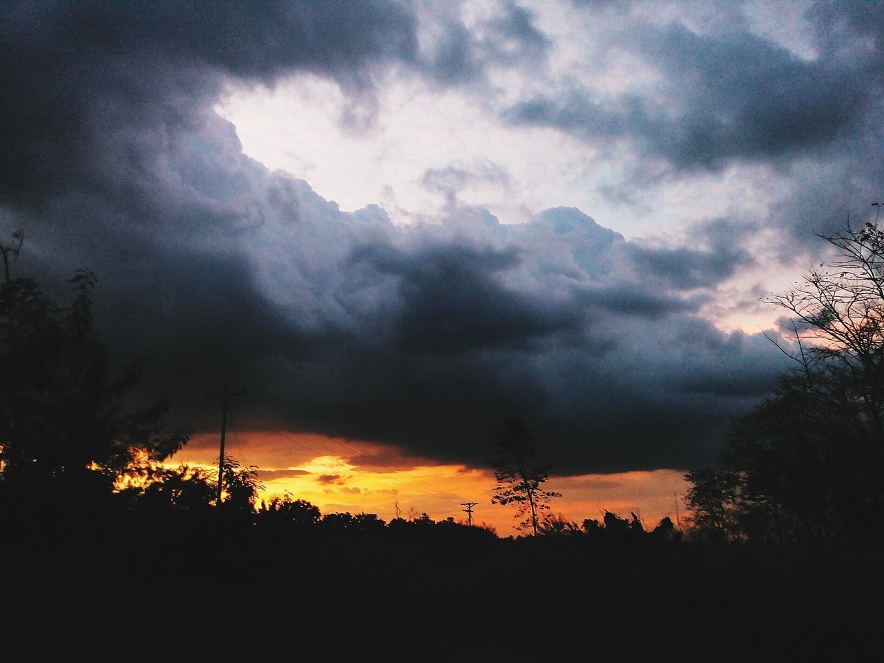 SILHOUETTE OF LANDSCAPE AGAINST CLOUDY SKY