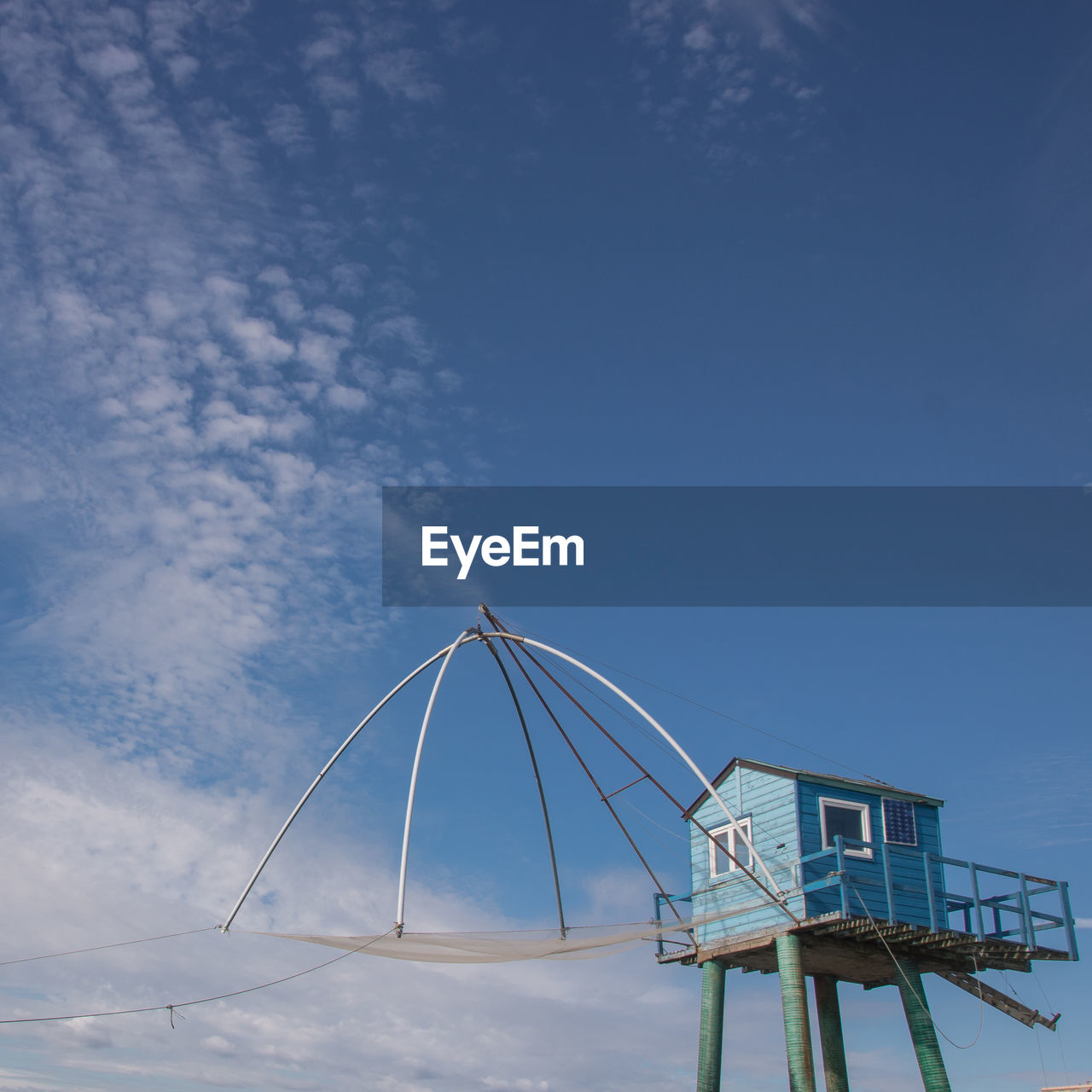 Low angle view of beach hut against blue sky