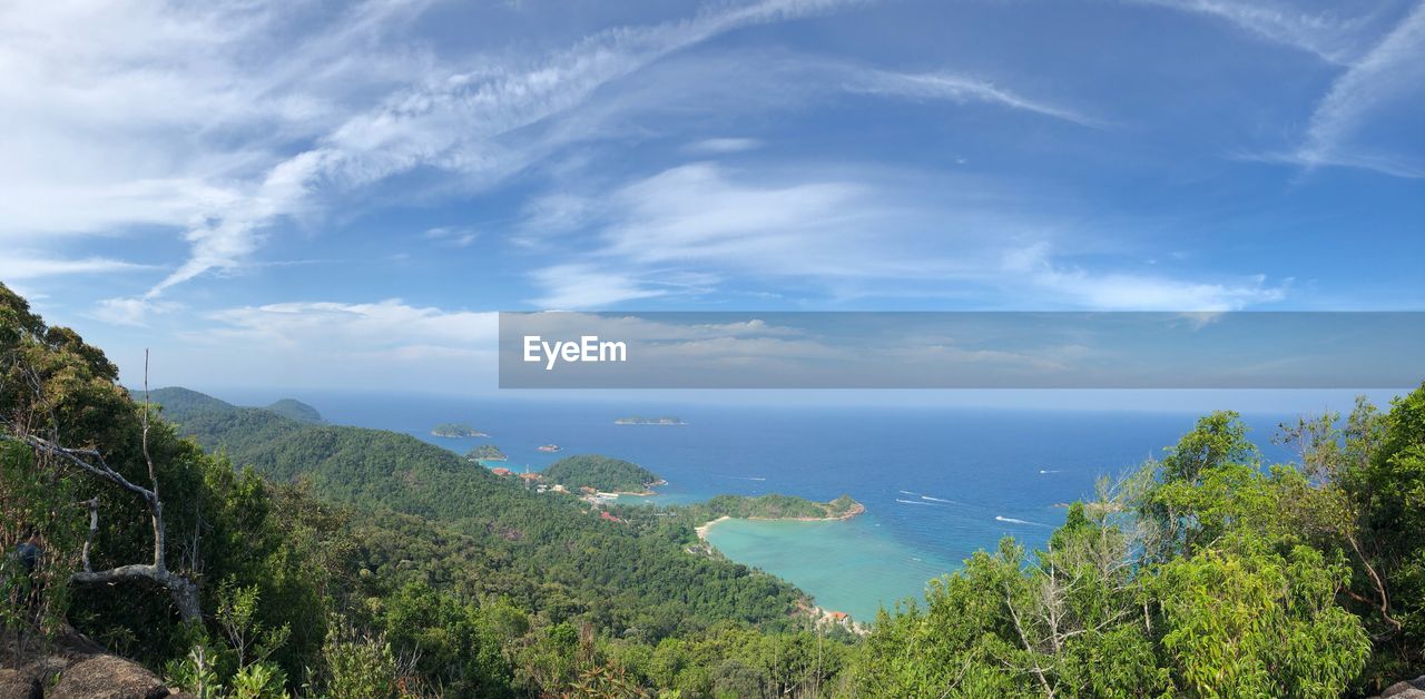 High angle view of trees and sea against sky