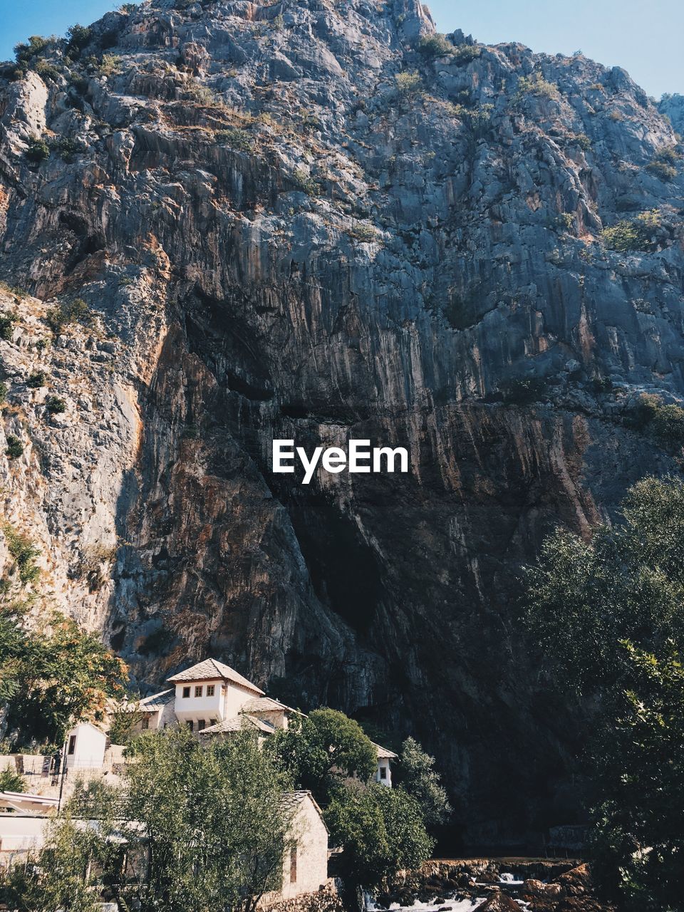 Aerial view of house and mountains against sky