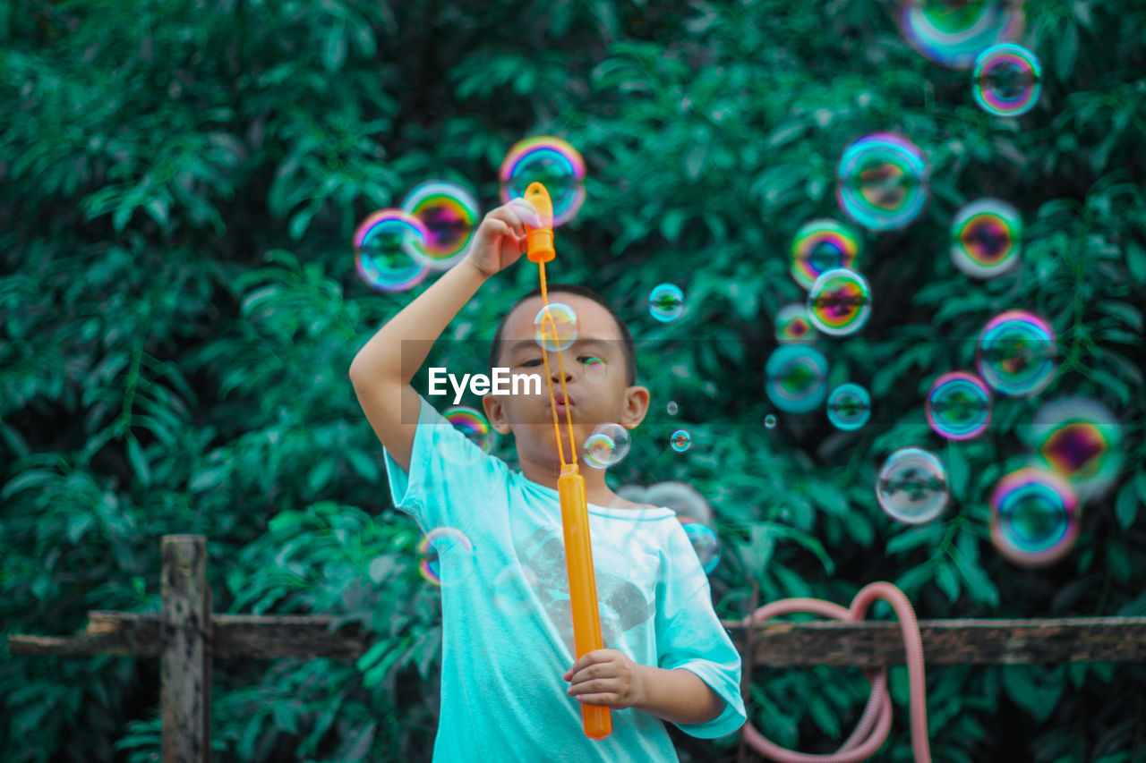 GIRL PLAYING WITH BUBBLES