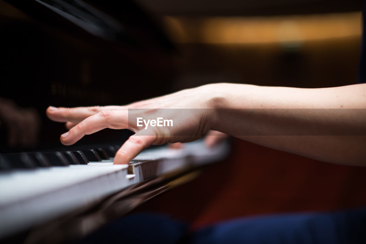 Midsection of man playing piano