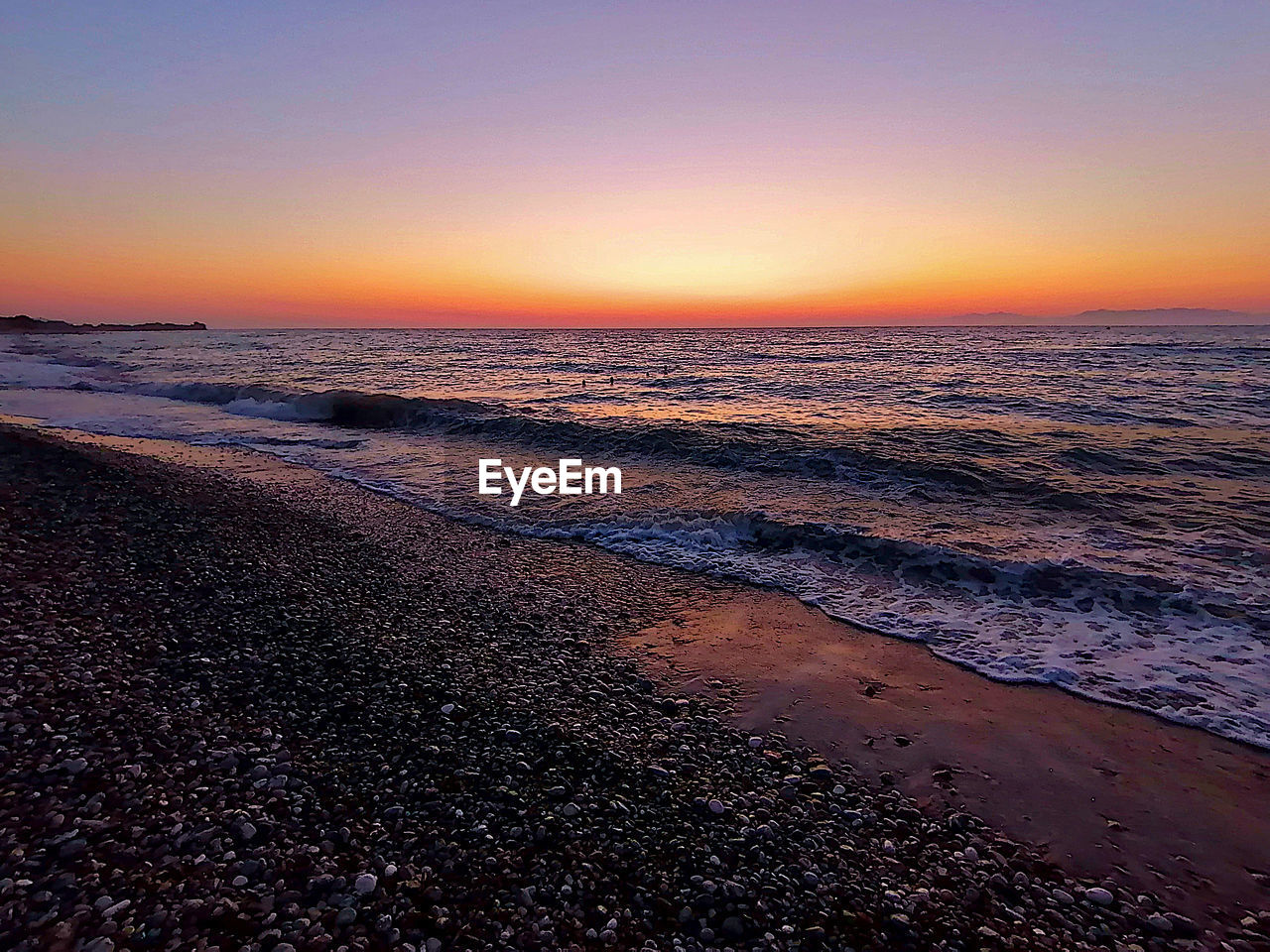 SCENIC VIEW OF SEA DURING SUNSET