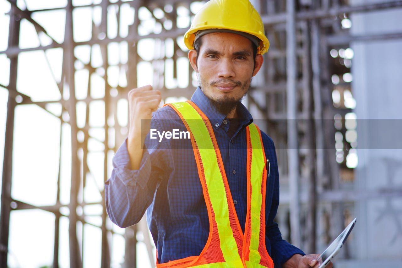 Portrait of smiling man working at construction site