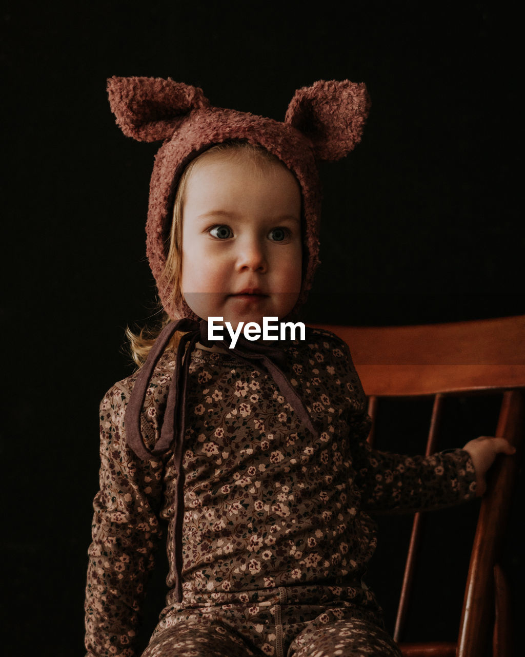 Toddler baby girl in funny hat with ears having fun