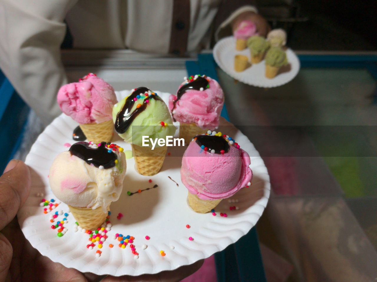 CLOSE-UP OF ICE CREAM ON TABLE