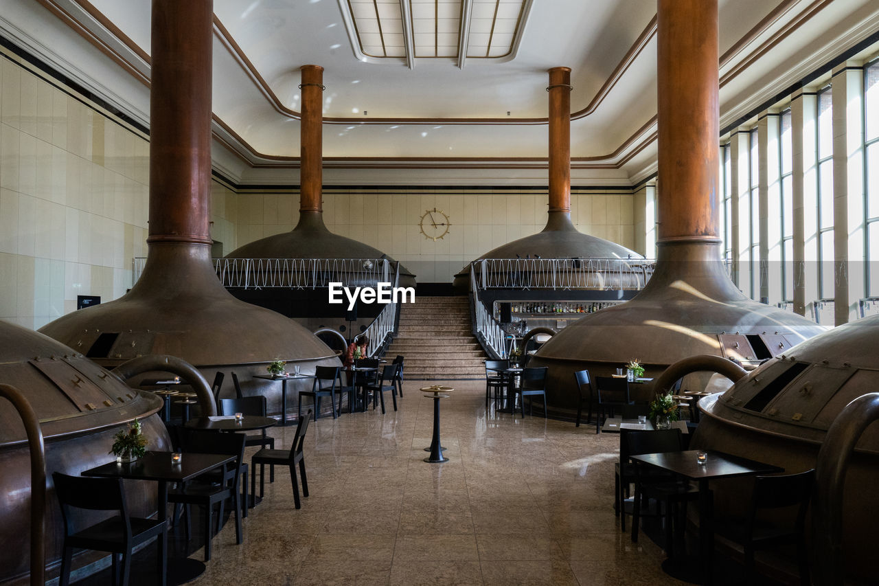 EMPTY CHAIRS AND TABLES IN ROW