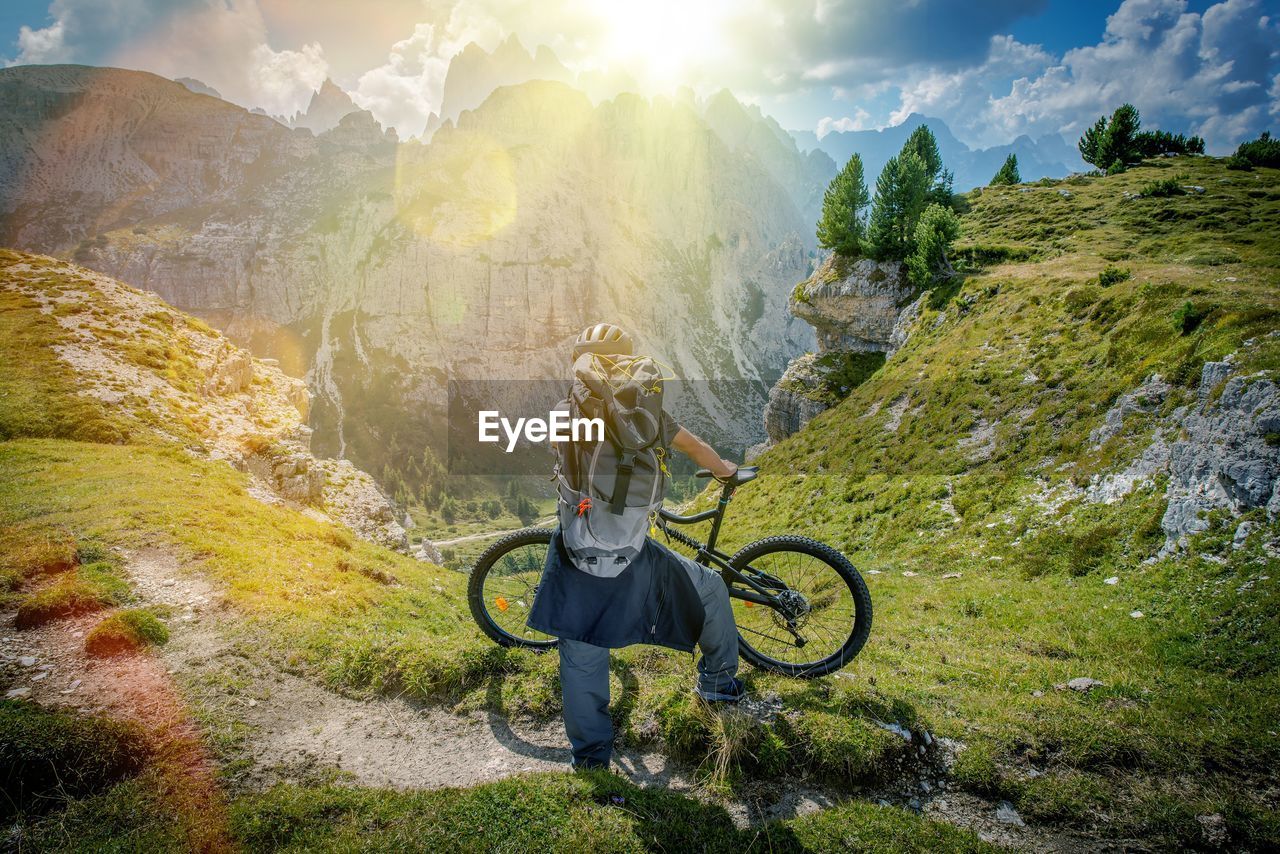 Man with bicycle on mountain