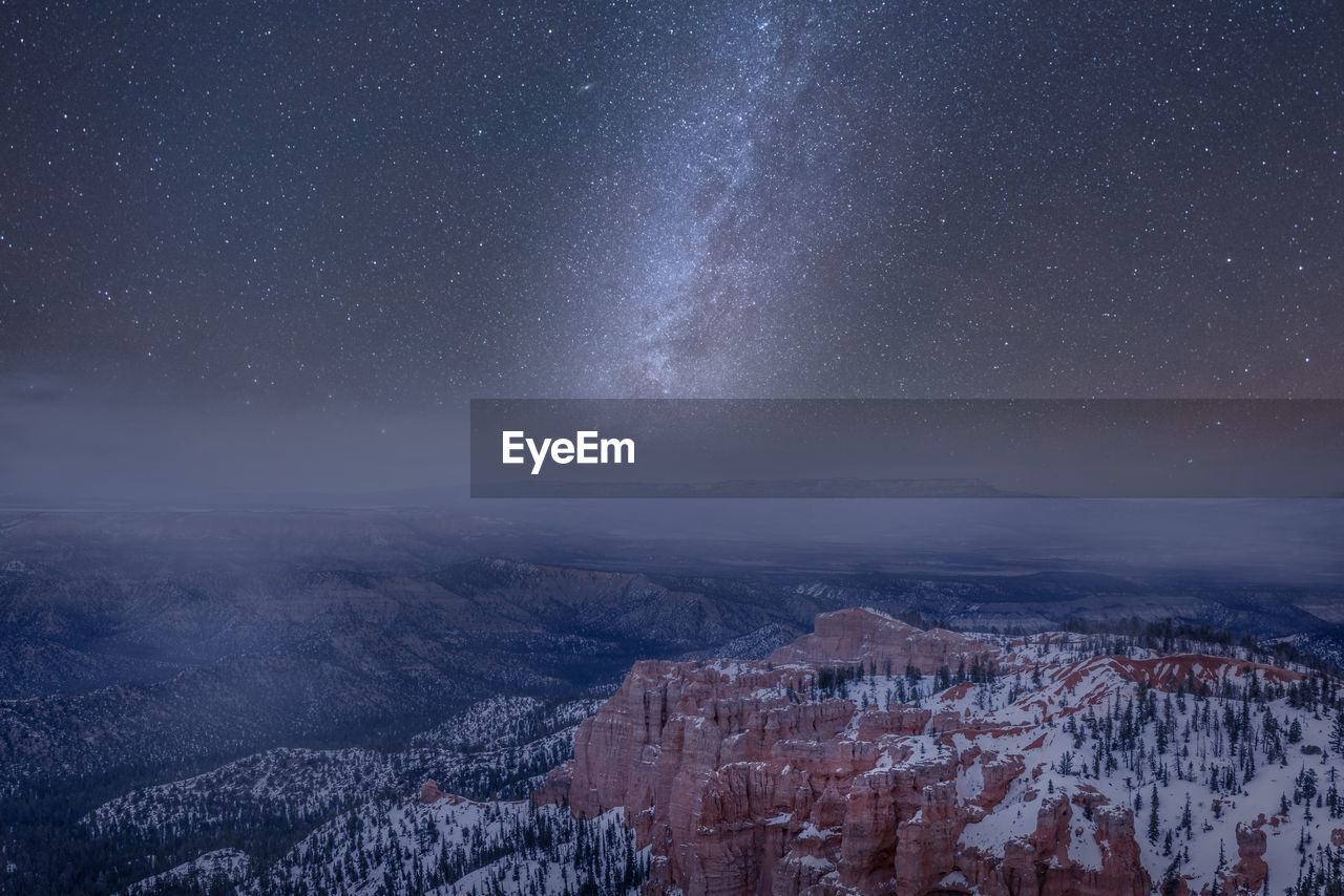 Aerial view of landscape against sky at night