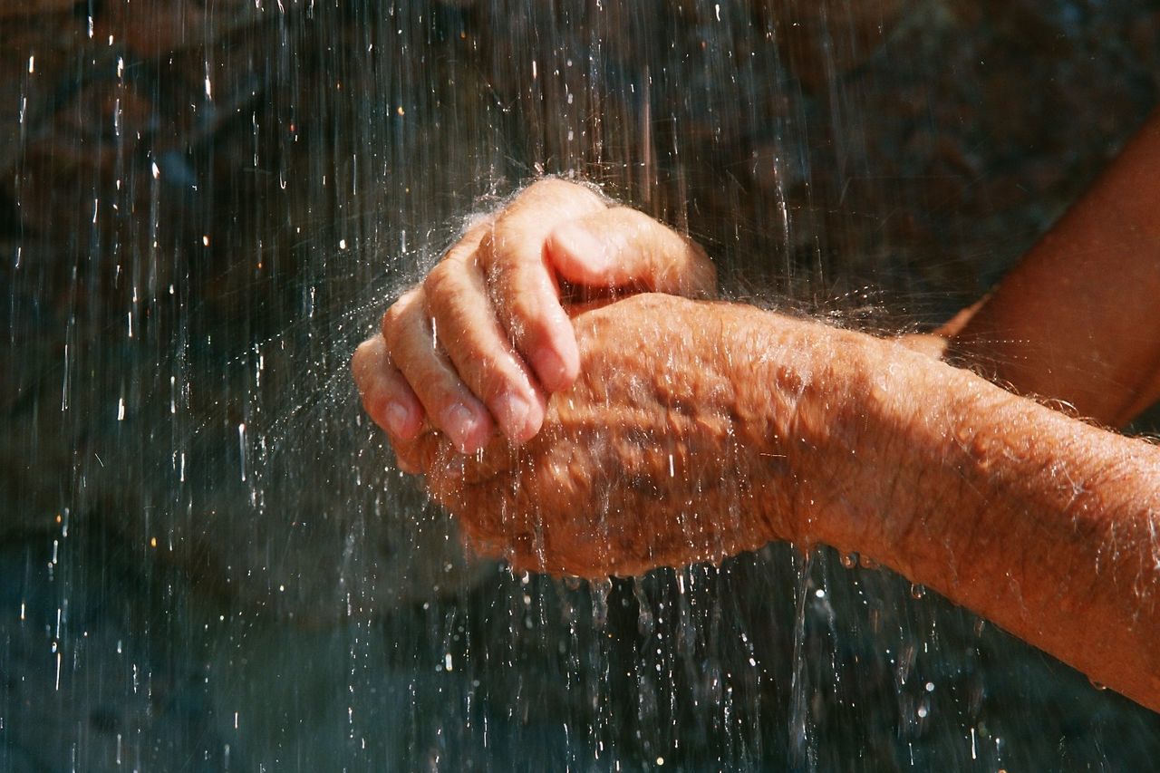 Close-up of a person hands in outdoor shower