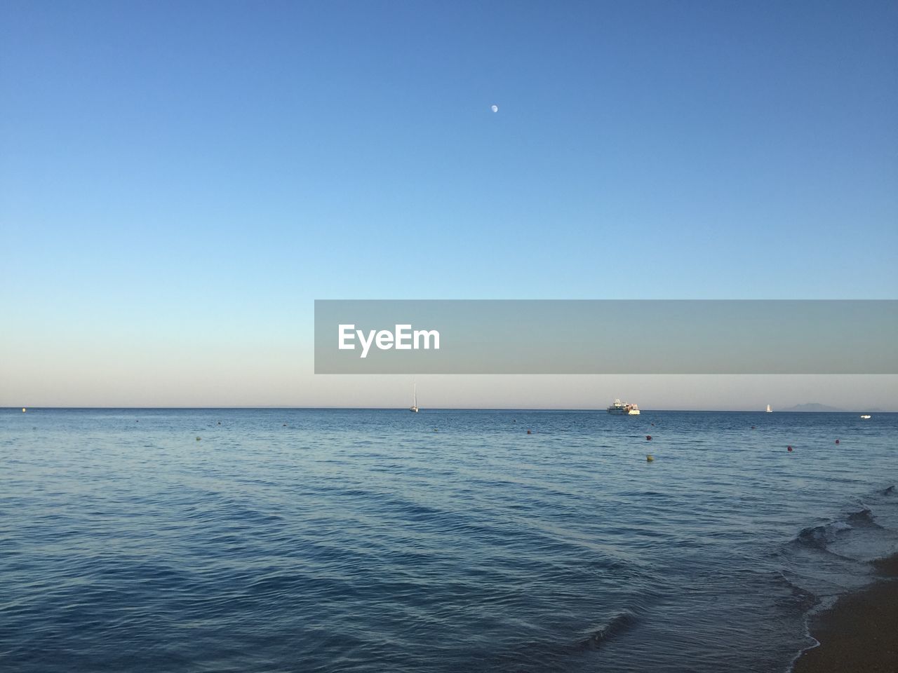 Scenic view of sea against clear blue sky