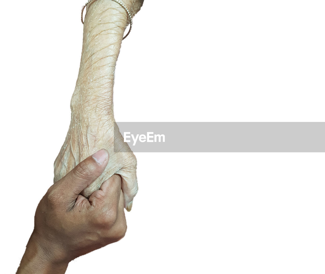 Close-up of people holding hands over white background