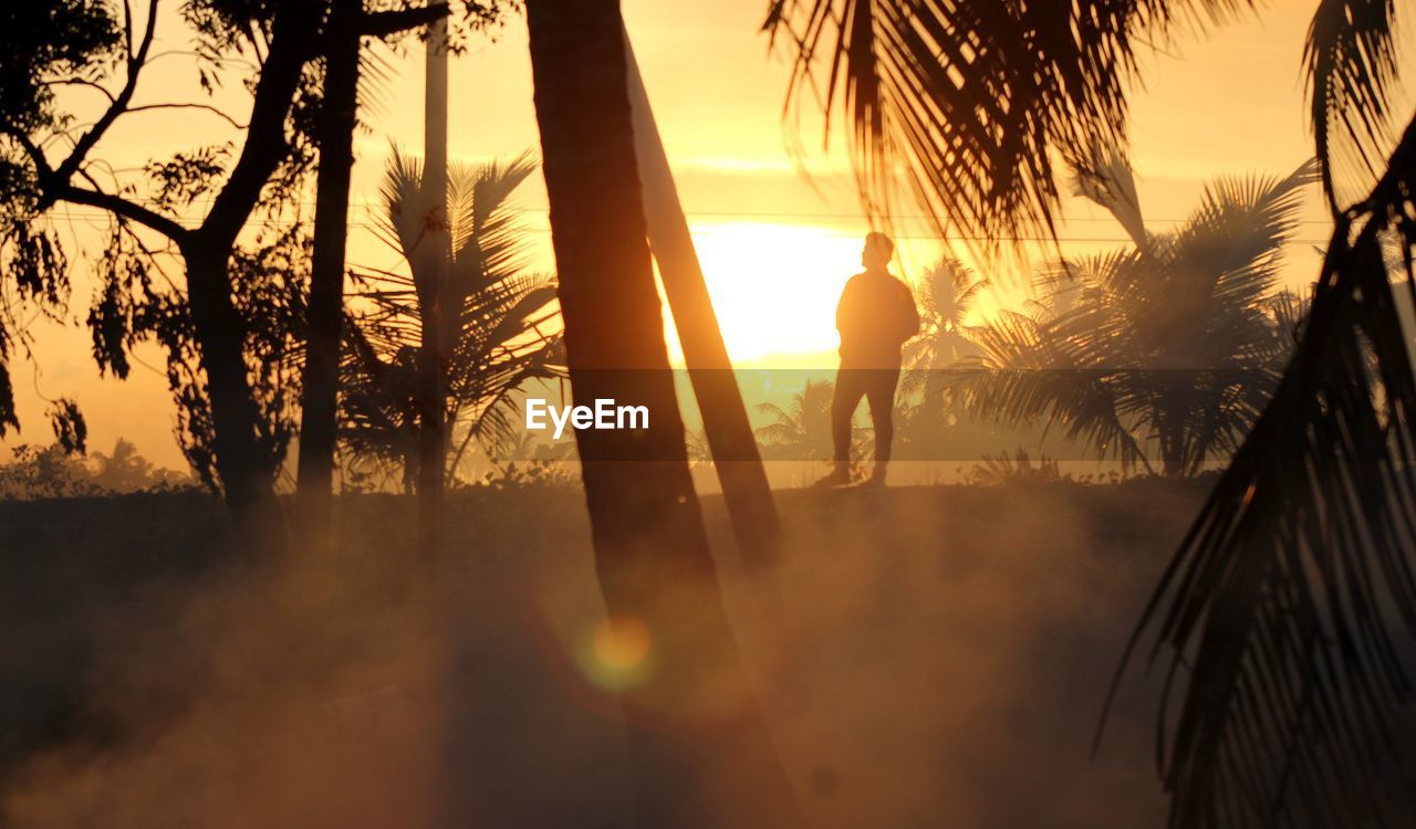 SILHOUETTE OF MAN AT SUNSET