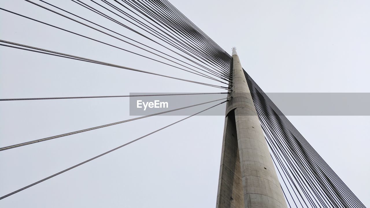 Low angle view of suspension bridge against clear sky