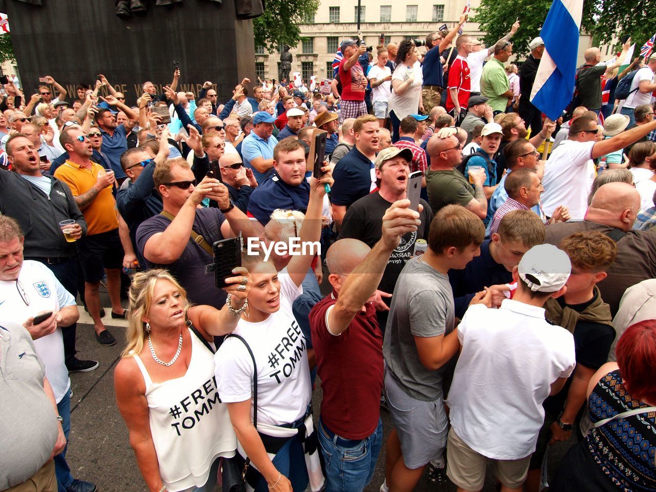 GROUP OF PEOPLE STANDING ON STREET